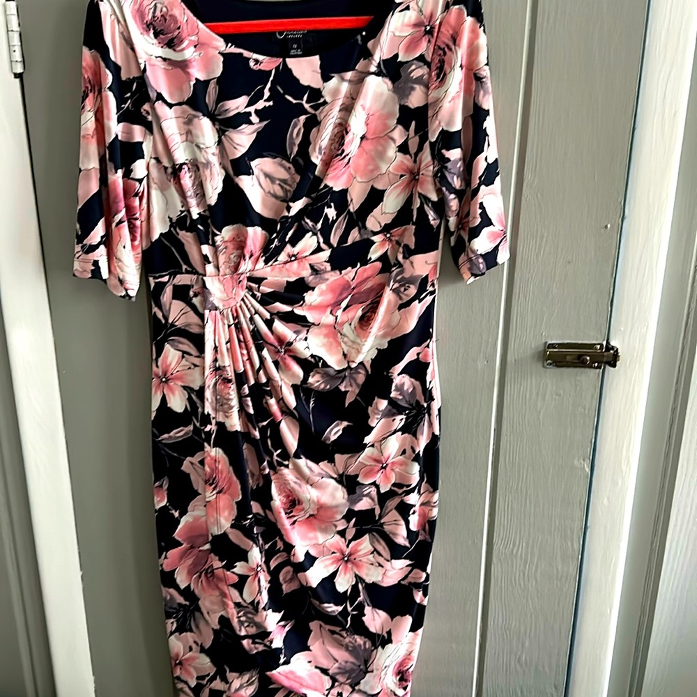 Pink floral knit dress with navy blue background, flattering side crunching